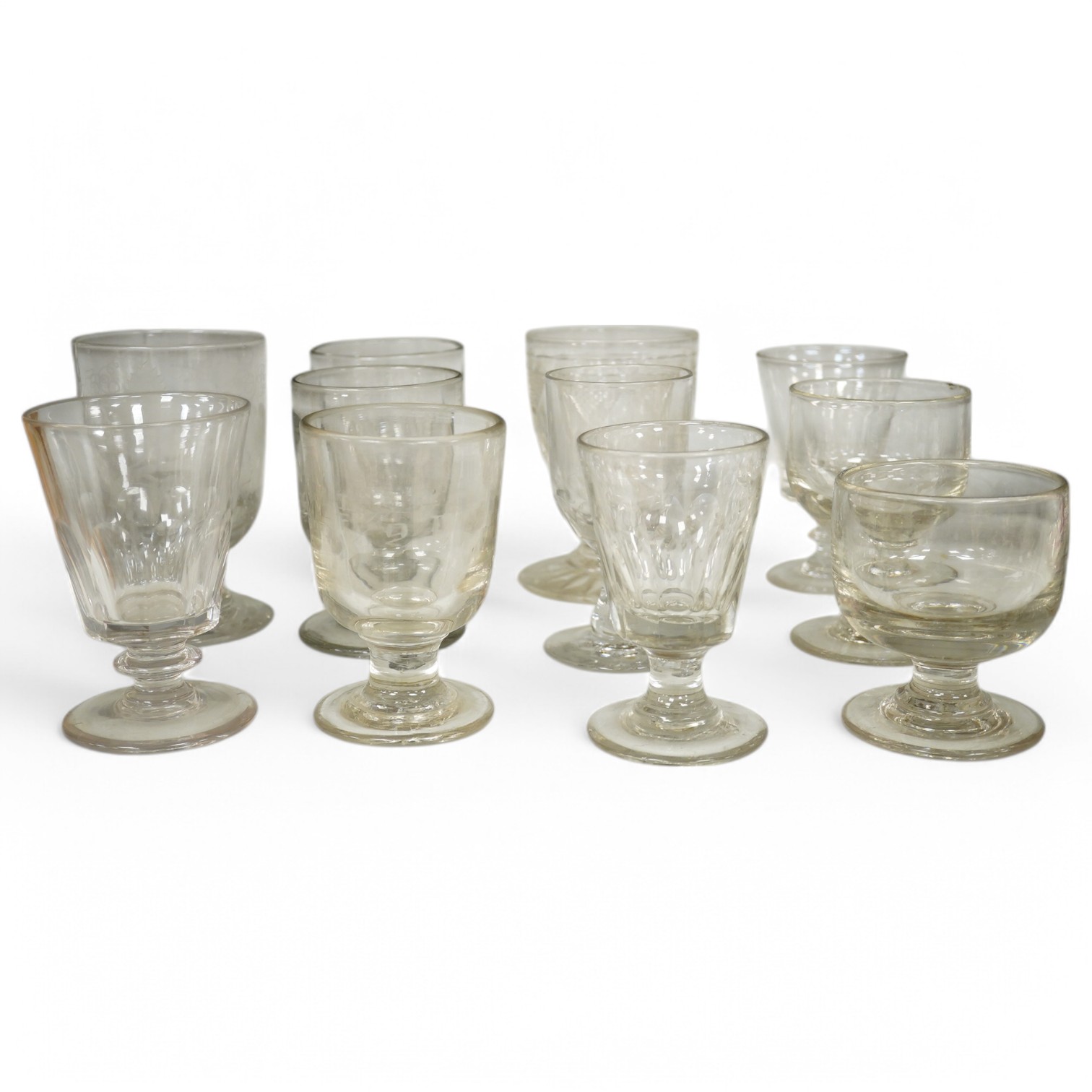 Eleven 19th century glass rummers including two engraved runners, one engraved with fruiting vines and dated 1867 (cracked). Condition - fair, one cracked, and a chip to the rim of another.